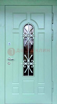 Светло-зеленая железная дверь со стеклом и ковкой ДСК-195 в Твери